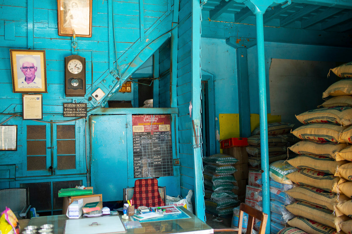 rustic room with bright blue walls and sacks of grains piled up on the side