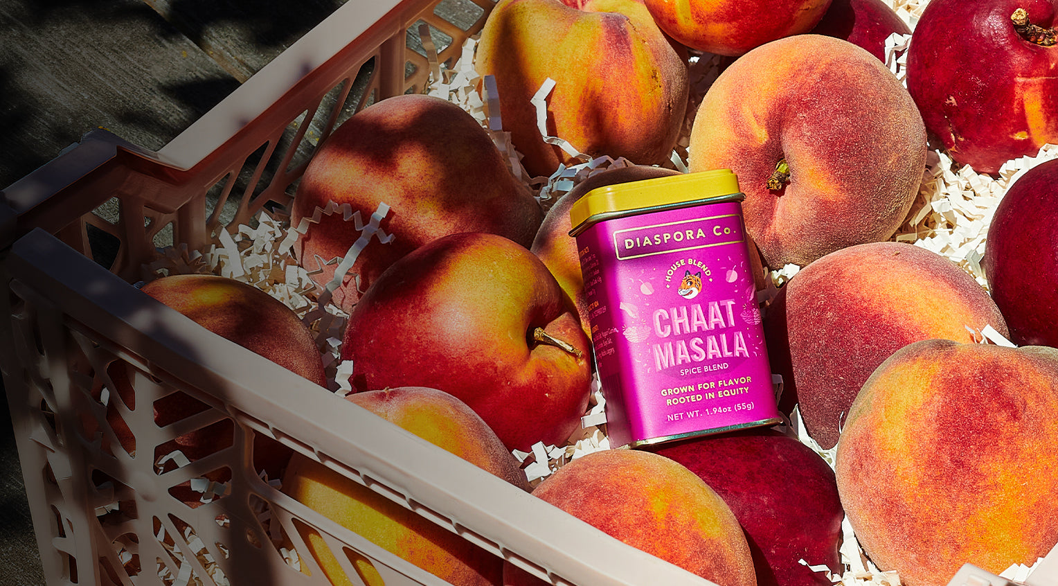 Chaat Masala tin kept against a background of fresh fruit