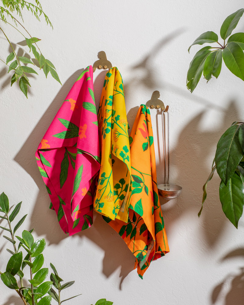 Photo of 3 floral dish towels hanging on hooks